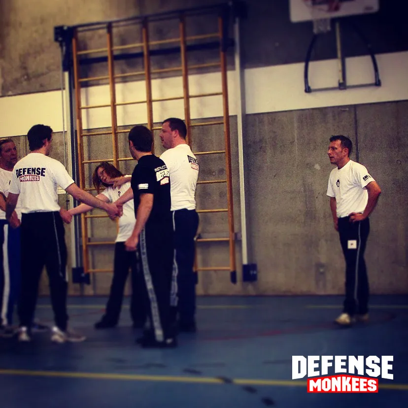 Krav Maga group class at Monkees: members practise a technique in pairs while the instructor watches
